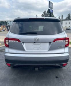 "Front exterior view of the 2022 Honda Pilot showcasing its bold design, LED headlights, and spacious midsize SUV profile."