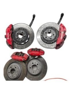 "Six piston Brembo brake kit with large performance rotors and red Brembo calipers installed on a high-performance vehicle."