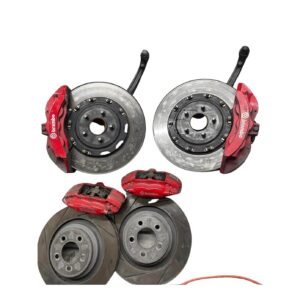 "Six piston Brembo brake kit with large performance rotors and red Brembo calipers installed on a high-performance vehicle."